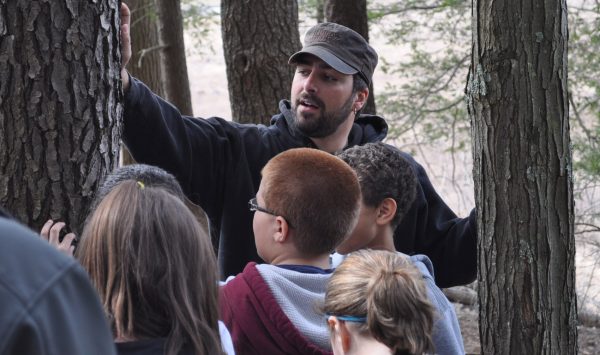 A Penn State student demonstrates tree identification