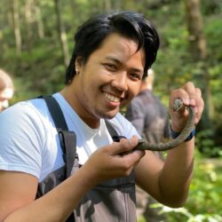 Krisna Chantharath holding a snake.