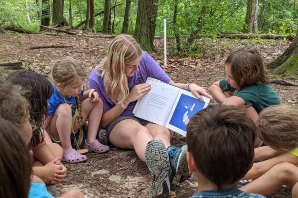 A Leader in Training shares a story with campers.