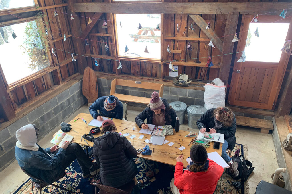 A group of people journaling at a table.